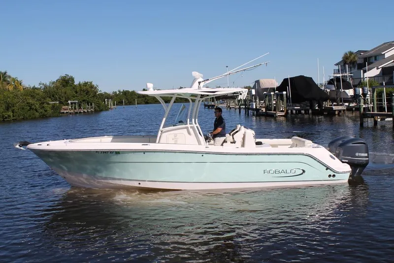 Slide: The Image of 2016 Robalo R300 Center Console boat cruising on a calm river. - 2