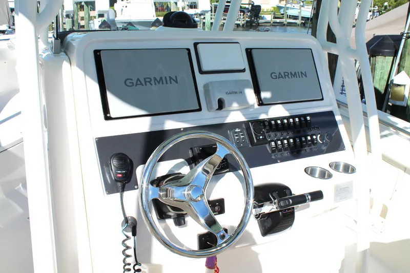 Slide: The Image of 2016 Robalo R300 Center Console dashboard with Garmin navigation displays and controls. - 23
