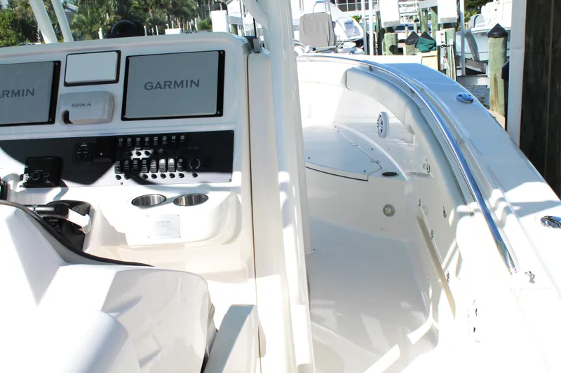 Slide: The Image of 2016 Robalo R300 Center Console boat with Garmin navigation system and sleek white interior. - 24