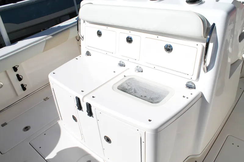 Slide: The Image of 2016 Robalo R300 Center Console boat interior with storage compartments and seating. - 26