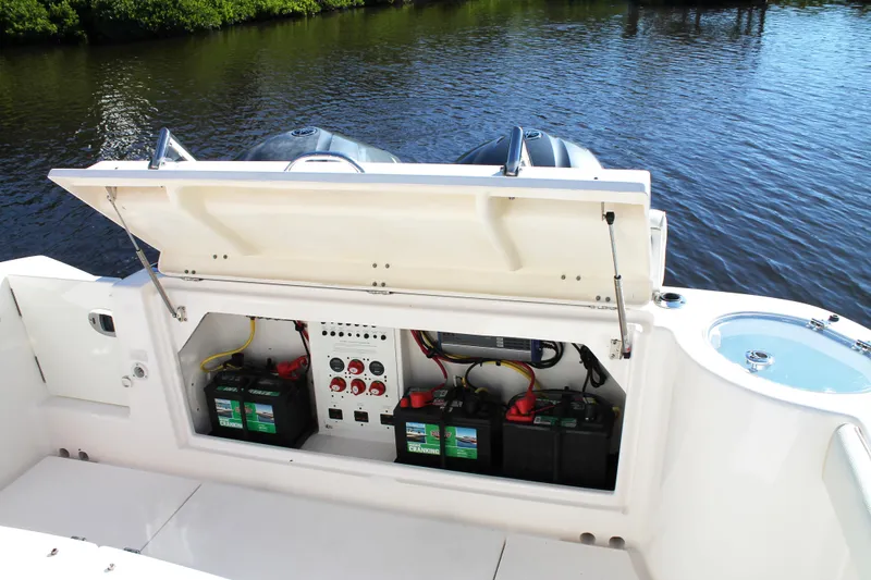 Slide: The Image of 2016 Robalo R300 Center Console boat battery compartment by the water. - 37