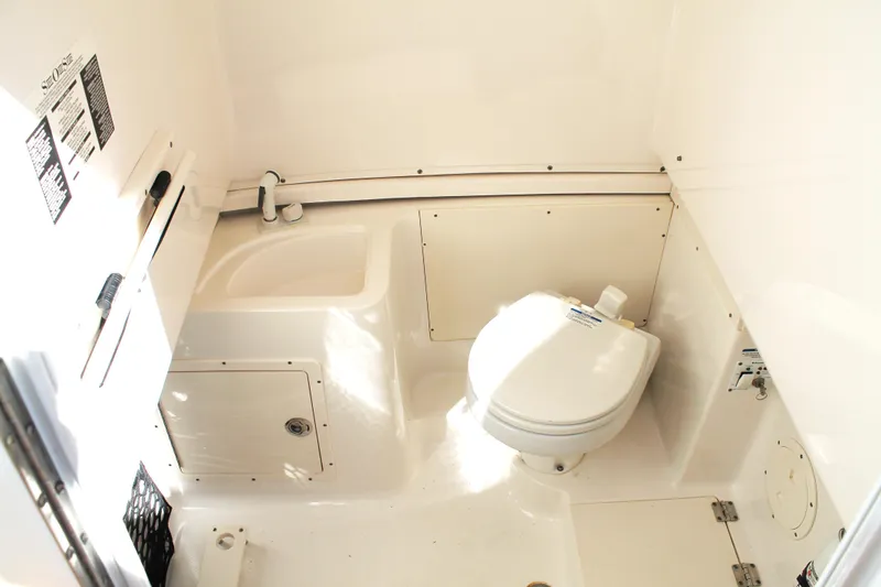 Slide: The Image of 2016 Robalo R300 Center Console boat interior with toilet and sink. - 38