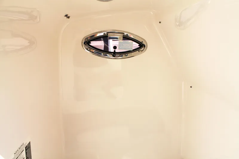 Slide: The Image of Interior cabin of 2016 Robalo R300 Center Console boat with oval window. - 39
