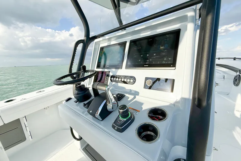Slide: The Image of 2026 Yellowfin 34 Offshore boat dashboard with modern controls and dual screens. - 10