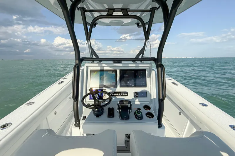 Slide: The Image of 2026 Yellowfin 34 Offshore boat dashboard with ocean view, featuring modern navigation equipment. - 11