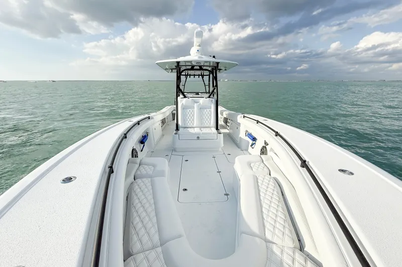 Slide: The Image of 2026 Yellowfin 34 Offshore boat on open water under cloudy sky. - 14