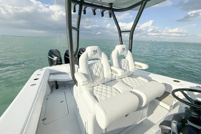 Slide: The Image of 2026 Yellowfin 34 Offshore boat with luxurious seating on calm waters. - 16