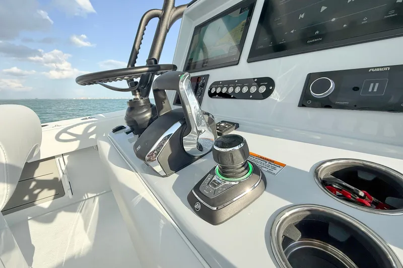 Slide: The Image of Control panel of 2026 Yellowfin 34 Offshore boat with steering wheel and navigation screens. - 18
