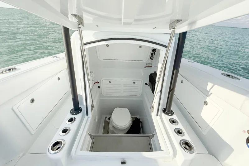 Slide: The Image of 2026 Yellowfin 34 Offshore boat interior with open hatch and marine toilet. - 20