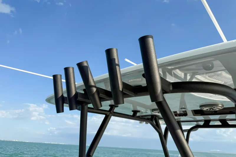 Slide: The Image of Rod holders on a 2026 Yellowfin 34 Offshore boat against a clear blue sky. - 22