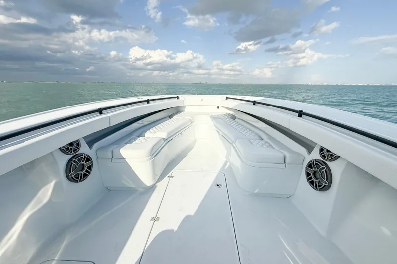 Slide: The Image of 2026 Yellowfin 34 Offshore boat interior with cushioned seating, ocean view, and clear sky. - 5