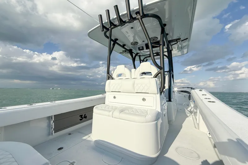 Slide: The Image of 2026 Yellowfin 34 Offshore boat on open water under cloudy sky. - 7