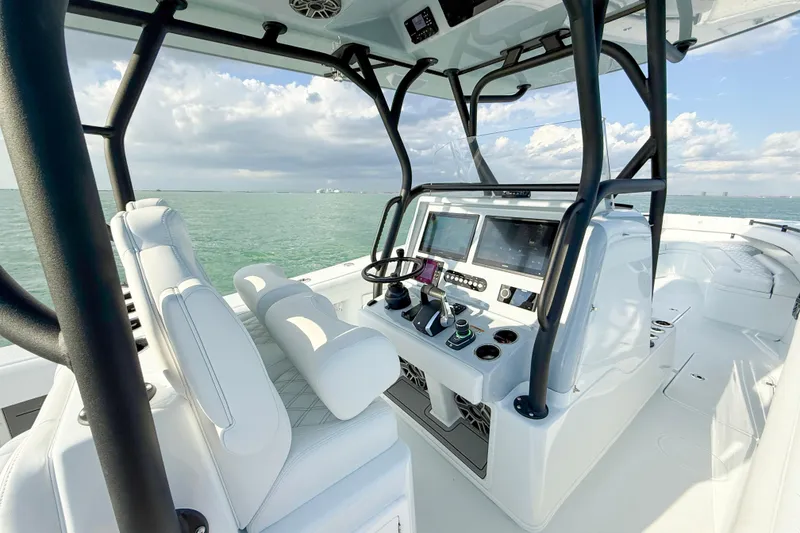 Slide: The Image of 2026 Yellowfin 34 Offshore boat interior with modern controls and ocean view. - 9
