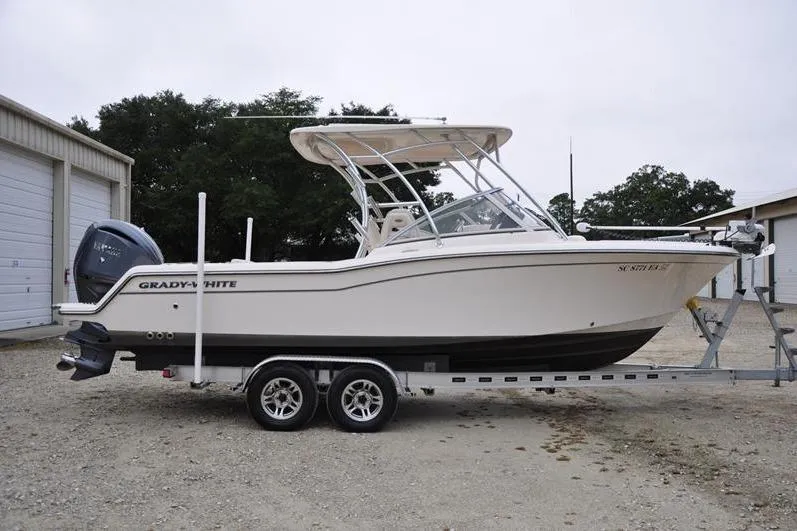 The Image of 2022 Grady-White Freedom 235 boat on trailer, parked outdoors. - 1