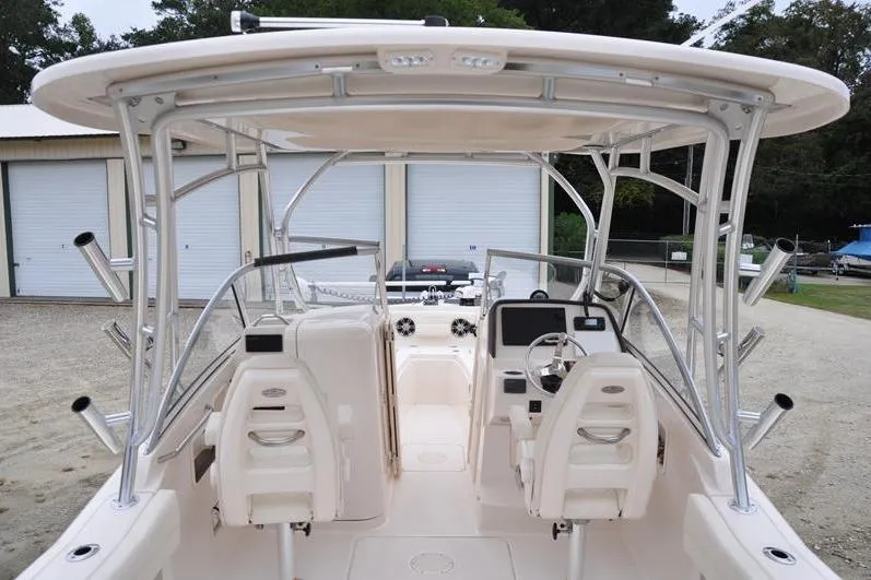 Slide: The Image of 2022 Grady-White Freedom 235 boat interior with helm and seating, parked outdoors. - 10