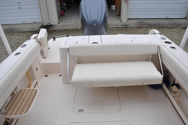 Slide: The Image of 2022 Grady-White Freedom 235 boat interior with seating and storage compartments. - 11