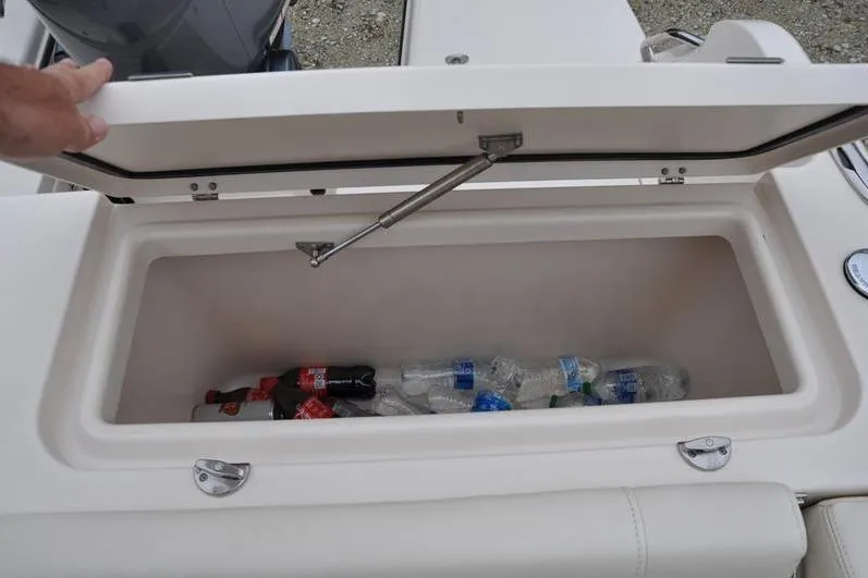 Slide: The Image of Open storage compartment on 2022 Grady-White Freedom 235 boat with drinks inside. - 13
