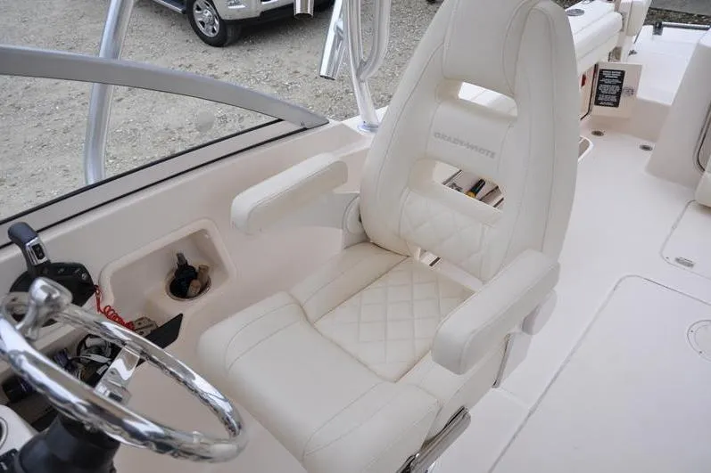 Slide: The Image of 2022 Grady-White Freedom 235 boat interior with luxurious white captain's chair. - 19