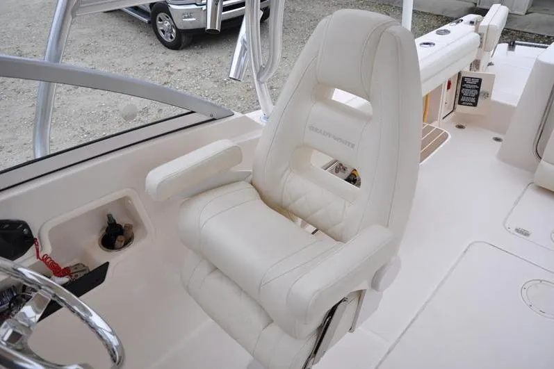 Slide: The Image of 2022 Grady-White Freedom 235 boat interior with luxurious white captain's chair. - 20