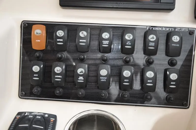 Slide: The Image of Control panel of 2022 Grady-White Freedom 235 boat with labeled switches. - 21