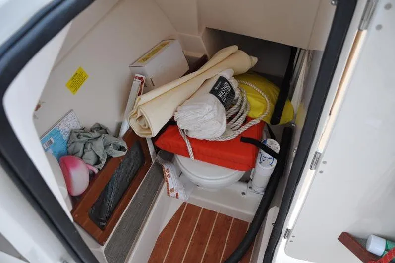 Slide: The Image of 2022 Grady-White Freedom 235 boat storage area with marine equipment and supplies. - 28