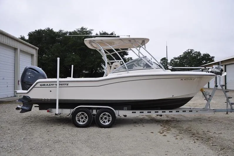 Slide: The Image of 2022 Grady-White Freedom 235 boat on trailer, parked outdoors. - 6