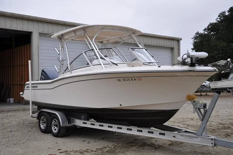 Slide: The Image of 2022 Grady-White Freedom 235 boat on trailer outside storage facility. - 7