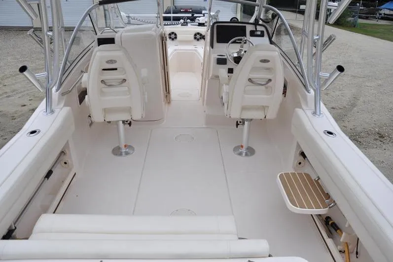 Slide: The Image of 2022 Grady-White Freedom 235 boat interior with dual helm seats and spacious deck. - 9