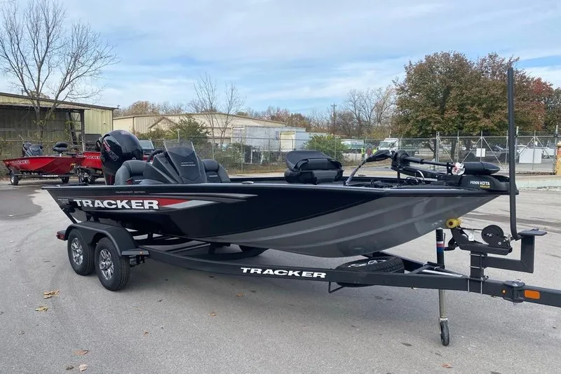 Slide: The Image of 2026 Tracker Pro Team 195 boat on trailer, parked outdoors, showcasing sleek design. - 62