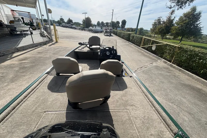 Slide: The Image of 2026 Tracker Bass Tracker Classic Limited boat with beige seats, parked outdoors. - 2