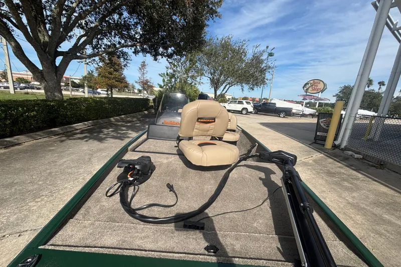 Slide: The Image of 2026 Tracker Bass Tracker Classic Limited boat with seating and trolling motor, parked outdoors. - 3