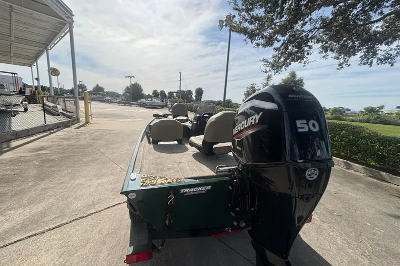 Slide: The Image of 2026 Tracker Bass Tracker Classic Limited boat with Mercury 50 engine on a sunny day. - 4