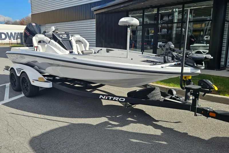 The Image of 2026 Nitro Z19 XL Pro boat on trailer, parked outside a building. - 0