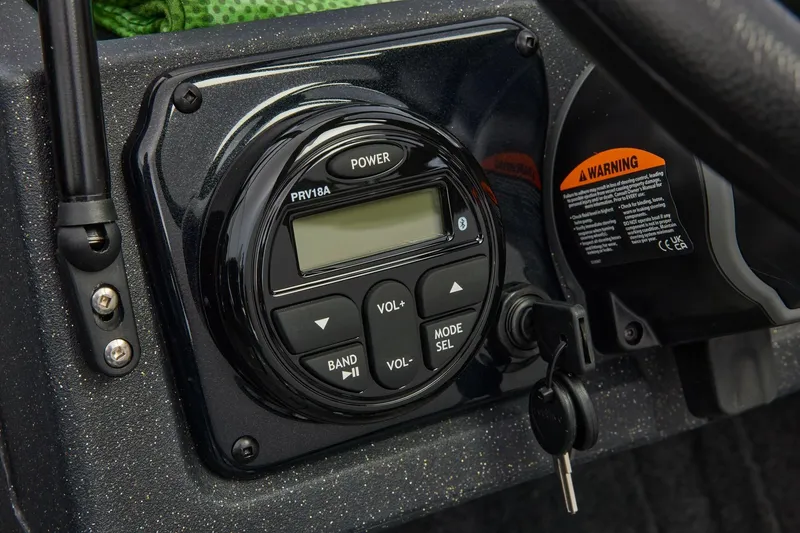 Slide: The Image of 2026 Tracker Targa V-19 Combo boat console with controls and key. - 24