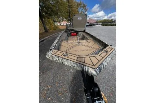 Slide: The Image of 2026 Tracker Grizzly 1650 T Prairie Wings Edition boat, parked outdoors on a sunny day. - 6