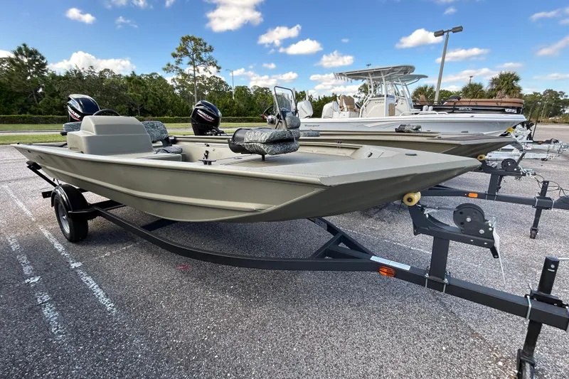 The Image of 2026 Tracker Grizzly 1754 SC boat on trailer, parked outdoors under blue sky. - 0