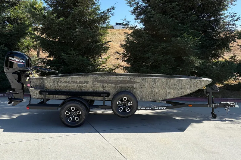 The Image of 2026 Tracker Grizzly 1650 T Prairie Wings Edition boat on trailer, outdoors. - 0