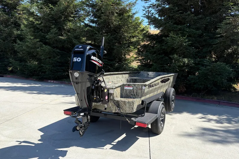 Slide: The Image of 2026 Tracker Grizzly 1650 T Prairie Wings Edition boat with Mercury 50 engine in outdoor setting. - 5