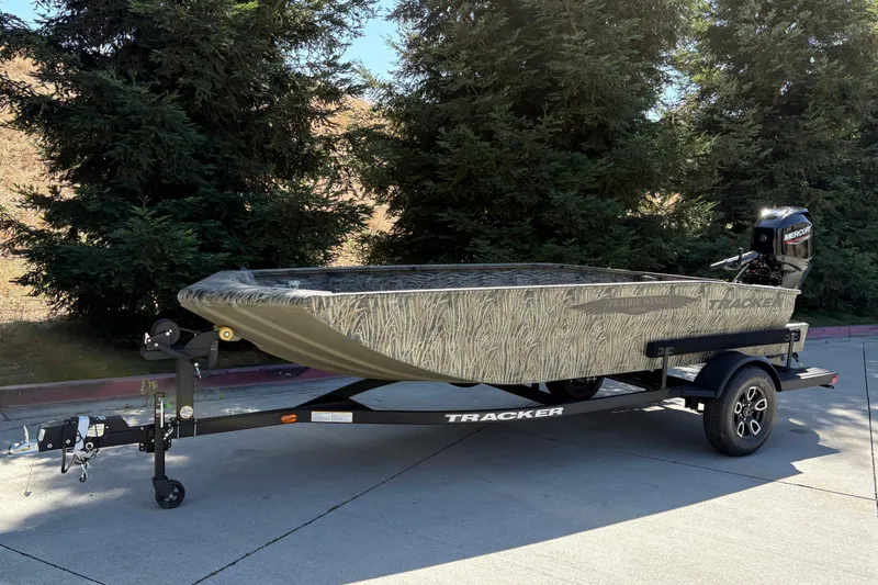 Slide: The Image of 2026 Tracker Grizzly 1650 T Prairie Wings Edition boat on trailer, outdoors. - 6