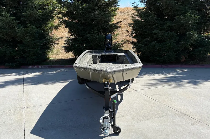 Slide: The Image of 2026 Tracker Grizzly 1650 T Prairie Wings Edition boat on trailer, parked outdoors. - 7