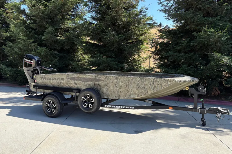 Slide: The Image of 2026 Tracker Grizzly 1650 T Prairie Wings Edition boat on trailer, outdoors. - 3