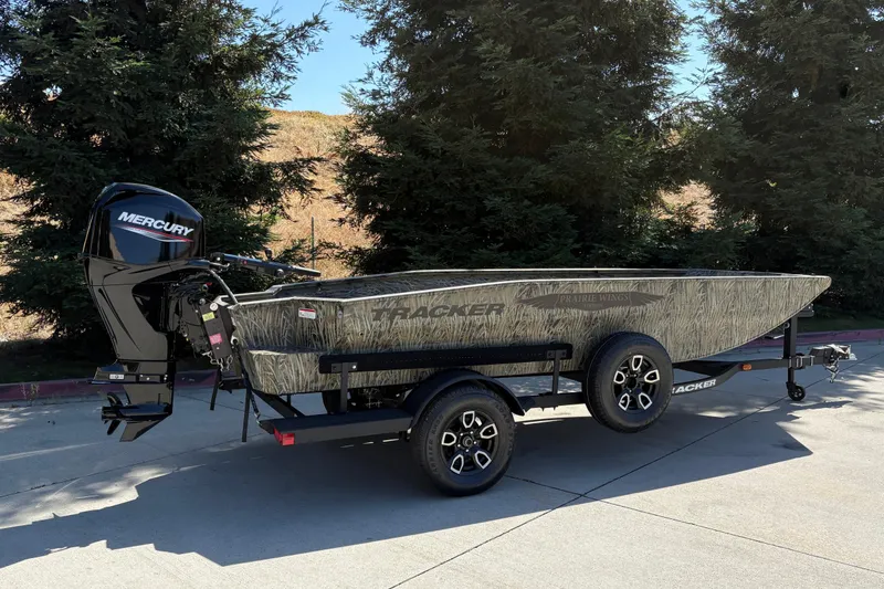 Slide: The Image of 2026 Tracker Grizzly 1650 T Prairie Wings Edition boat with Mercury engine on trailer. - 4