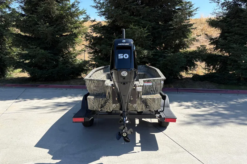 Slide: The Image of 2026 Tracker Grizzly 1650 T Prairie Wings Edition boat on trailer, rear view. - 9