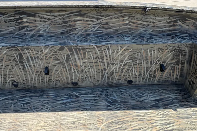 Slide: The Image of 2026 Tracker Grizzly 1650 T Prairie Wings Edition boat interior with camouflage design. - 27