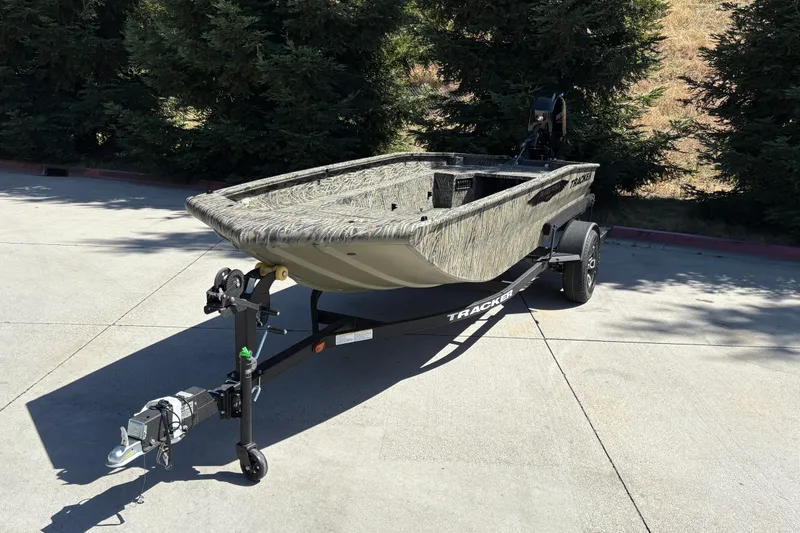 Slide: The Image of 2026 Tracker Grizzly 1650 T Prairie Wings Edition boat on trailer, parked outdoors. - 8