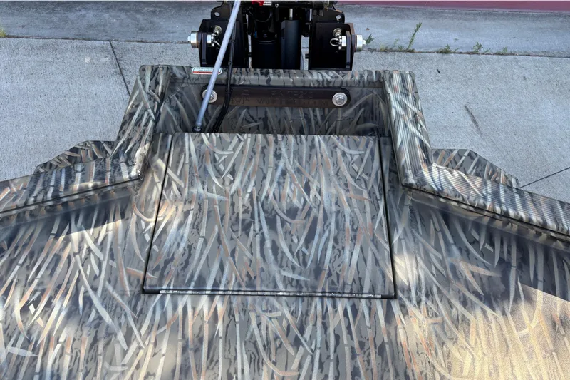 Slide: The Image of 2026 Tracker Grizzly 1650 T Prairie Wings Edition with camouflage pattern on a concrete surface. - 19