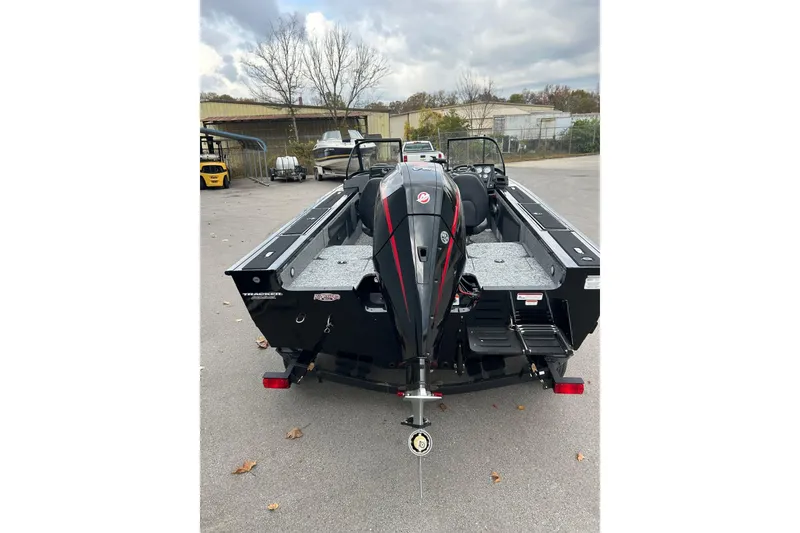 Slide: The Image of 2026 Tracker Targa V-19 Combo boat, rear view, parked outdoors on a cloudy day. - 3