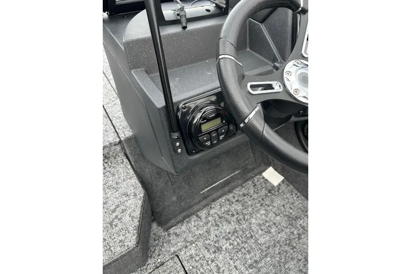 Slide: The Image of 2026 Tracker Targa V-19 Combo boat interior with green navigation light and water bottle. - 8