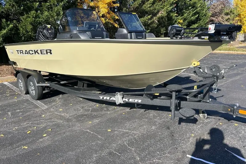 Slide: The Image of 2026 Tracker Targa V-19 Combo boat on trailer, side view, beige color. - 2