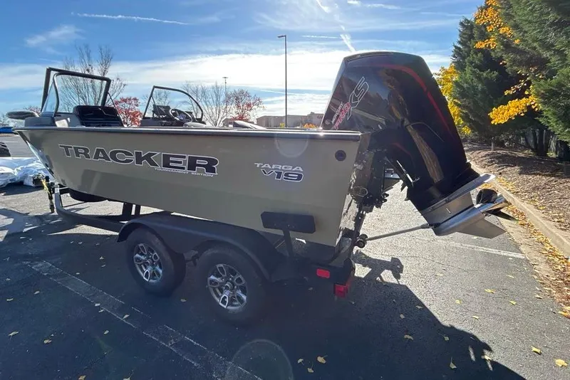 Slide: The Image of 2026 Tracker Targa V-19 Combo boat on trailer, parked outdoors under clear sky. - 5
